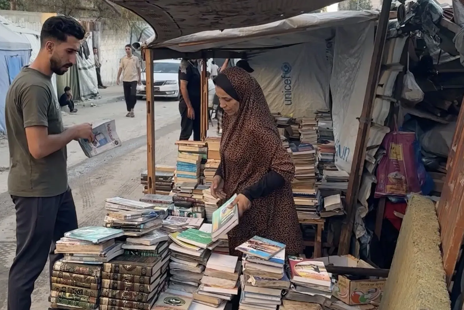 Gaza woman rescues books from rubble to keep education alive