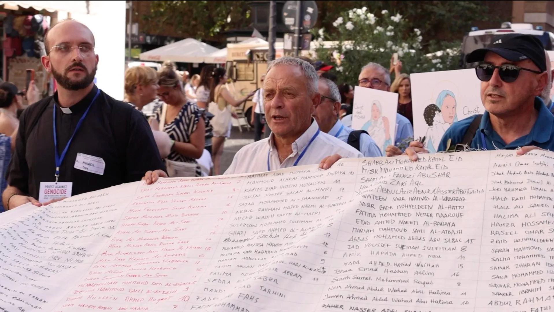 Priests Against Genocide hold shroud with names of children killed in Gaza