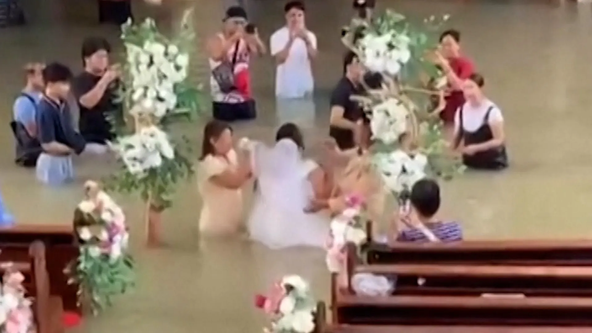 Bride walks down the aisle despite waist-deep flooding